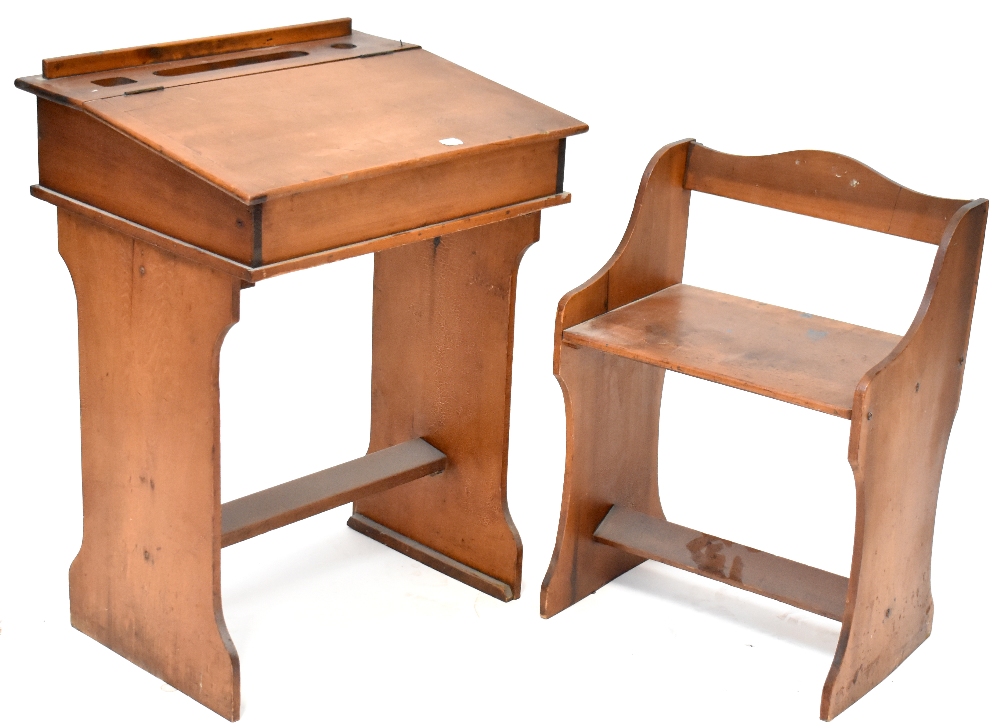 An early 20th century child's desk with push-under seat,