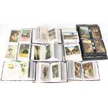 Ten albums of mostly vintage postcards sorted into various categories to include song cards,