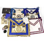 A brown leather case containing a collection of Masonic regalia to include Apron, sashes, gloves,