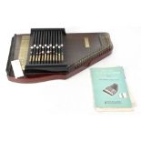 A vintage wooden body autoharp, length 52cm, with booklet.