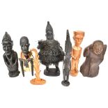 Six 20th century African wooden carvings comprising four figures, one with beads and a cloth outfit,