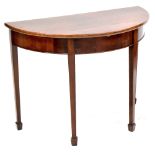 A 19th century flame mahogany demi-lune table, four tapering block supports to peg feet,