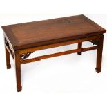 An Oriental hardwood coffee table of rectangular form with pierced corner brackets to apron,