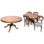 A late 19th/early 20th century mahogany oval dining table on turned baluster and quadripartite