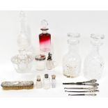 A group of cut-glass trinket pots and perfume bottles with hallmarked silver collars and tops,