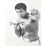 MUHAMMAD ALI; a black and white photograph bearing his signature and indistinct date.