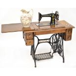 A Singer sewing machine with plate stamped 'V740524' within an oak and iron treadle base fitted