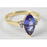 A 14ct yellow gold ring set with marquise cut tanzanite flanked by chip diamonds, size N, approx 2.