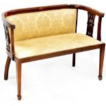 An Edwardian mahogany salon sofa, curved back rail to curving outswept arms with string inlay,