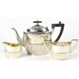 A George V hallmarked silver Georgian shape three-piece tea service, Walker & Hall, Sheffield 1916,