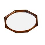 A 1940s oak oval mirror with bevelled plate,