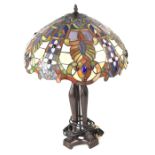 A 20th century Art Deco style table lamp with Tiffany-style shade to a bronzed Neo-Classical style