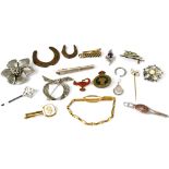 A quantity of vintage brooches, tie clips, etc.