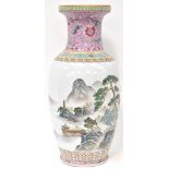 A reproduction Chinese baluster vase decorated with continuous mountainous landscape with trees,