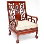 A modern Oriental hardwood open arm elbow chair with lattice back decoration centred with a dragon,
