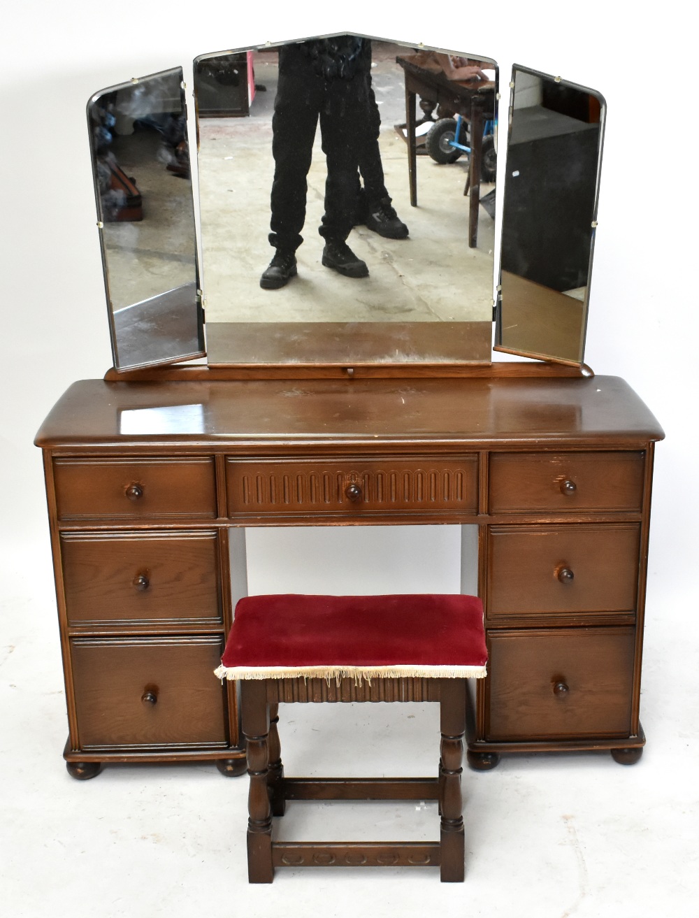 A reproduction elm Priory style mirror back dressing table, with an arrangement of seven drawers,