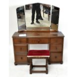 A reproduction elm Priory style mirror back dressing table, with an arrangement of seven drawers,
