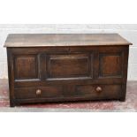 A George III oak mule chest, with hinged top above a panelled front and two short drawers, on
