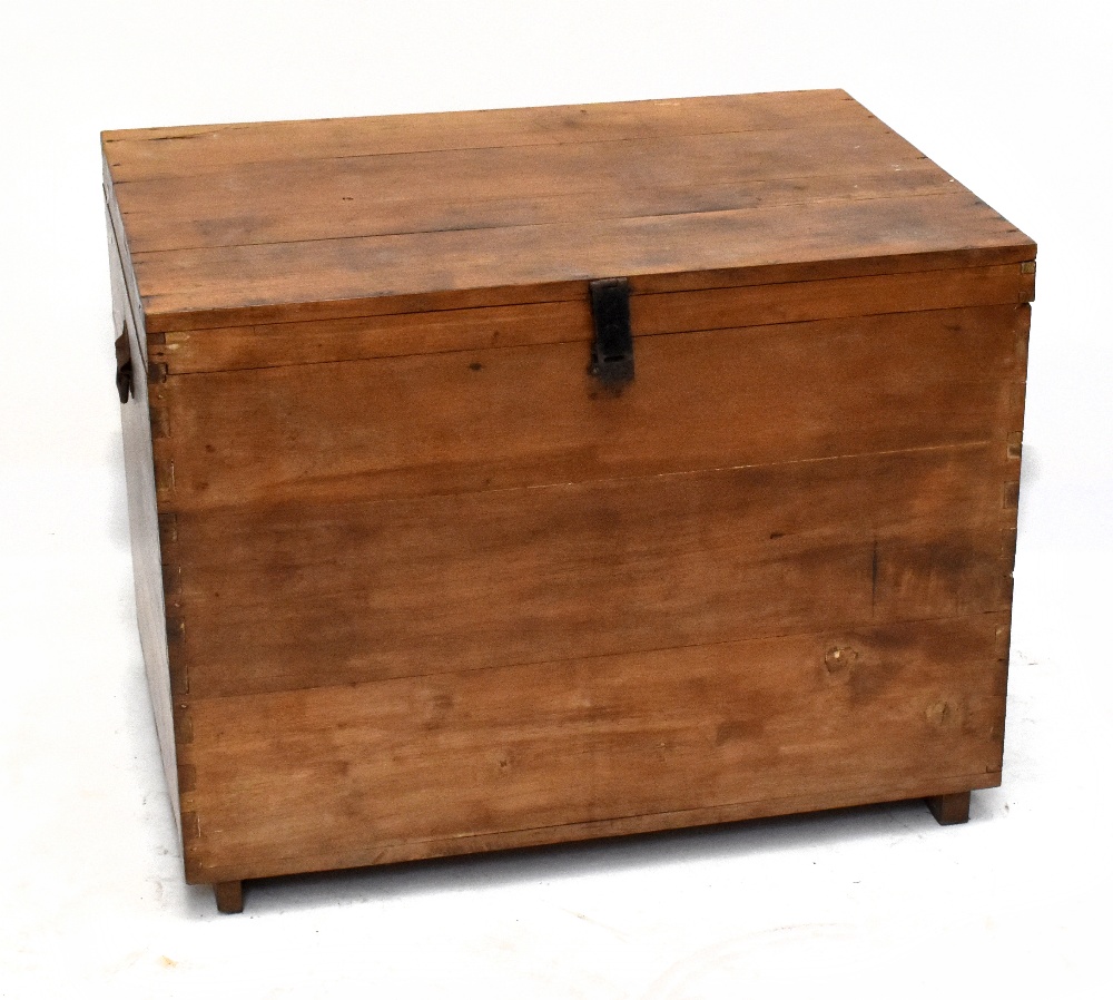 An early 20th century teak trunk of rectangular form, with cast metal side handles, width 90cm,