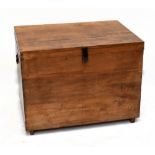 An early 20th century teak trunk of rectangular form, with cast metal side handles, width 90cm,