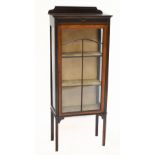 An Edwardian inlaid mahogany display cabinet with single glazed door enclosing two fixed shelves and