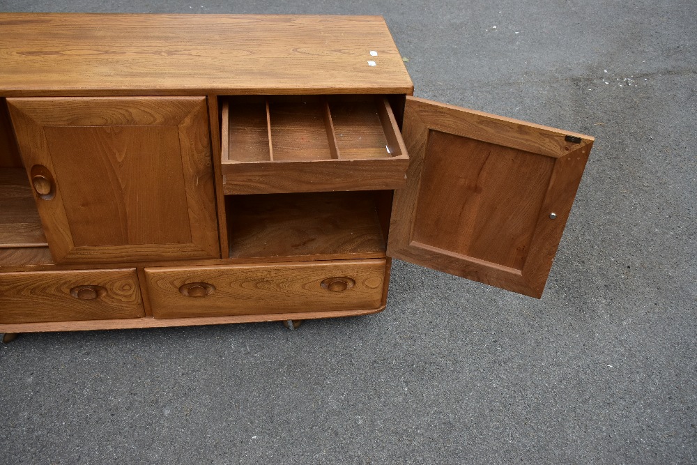 ERCOL; a light elm sideboard, the three panel doors above two base drawers, width 129cm, depth 43cm, - Image 9 of 12
