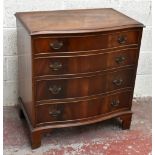 A reproduction mahogany veneered serpentine fronted chest of four drawers, with swan neck handles,
