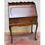 A 1920s mahogany bureau with 3/4 serpentine gallery above a panelled fall, over a long drawer, on