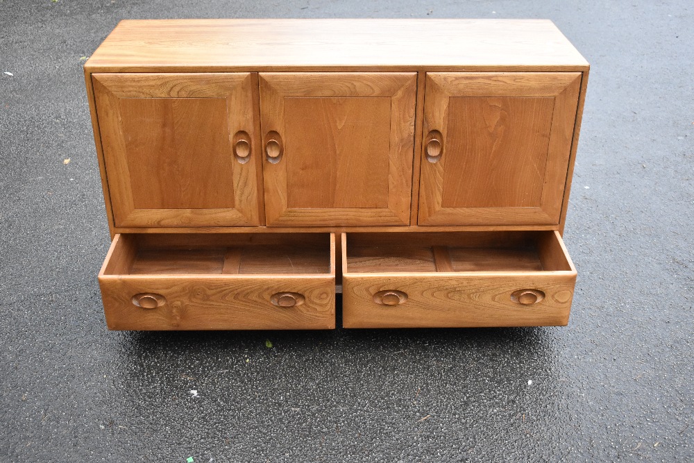 ERCOL; a light elm sideboard, the three panel doors above two base drawers, width 129cm, depth 43cm, - Image 12 of 12