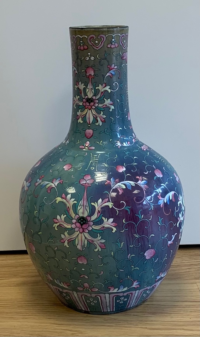 A large 18th century Chinese flambé vase, later enamel painted with stylised floral sprays, base