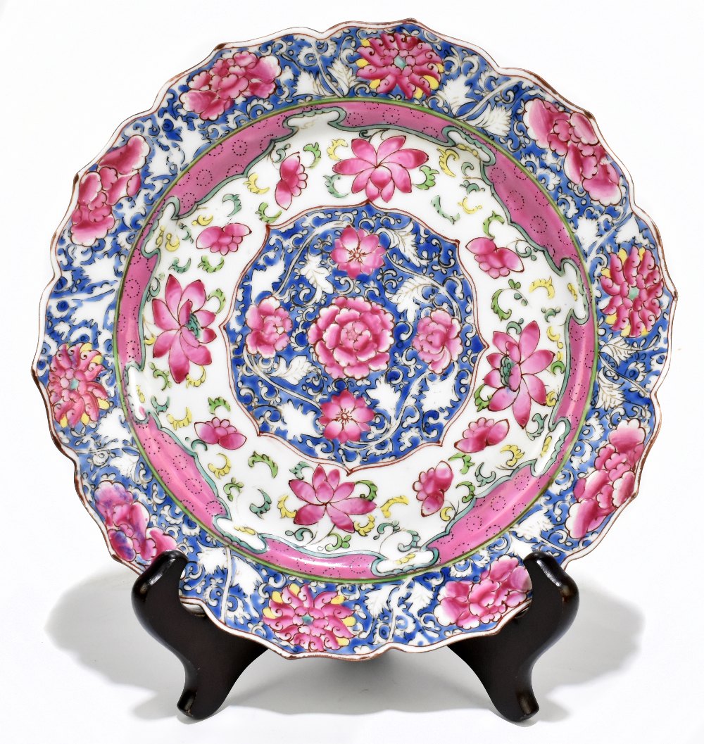 A late 18th century Chinese Famille Rose porcelain plate with scalloped edge, painted in enamels