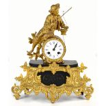 A 19th century French eight day gilt spelter and marble mantel clock with enamel Roman numeral