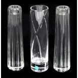 TIFFANY & CO; a pair of clear glass candle holders, each with moulded linear decoration, height 20.