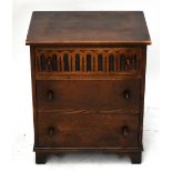 An oak Priory style three drawer chest of drawers, raised on bracket feet, height 61cm, width