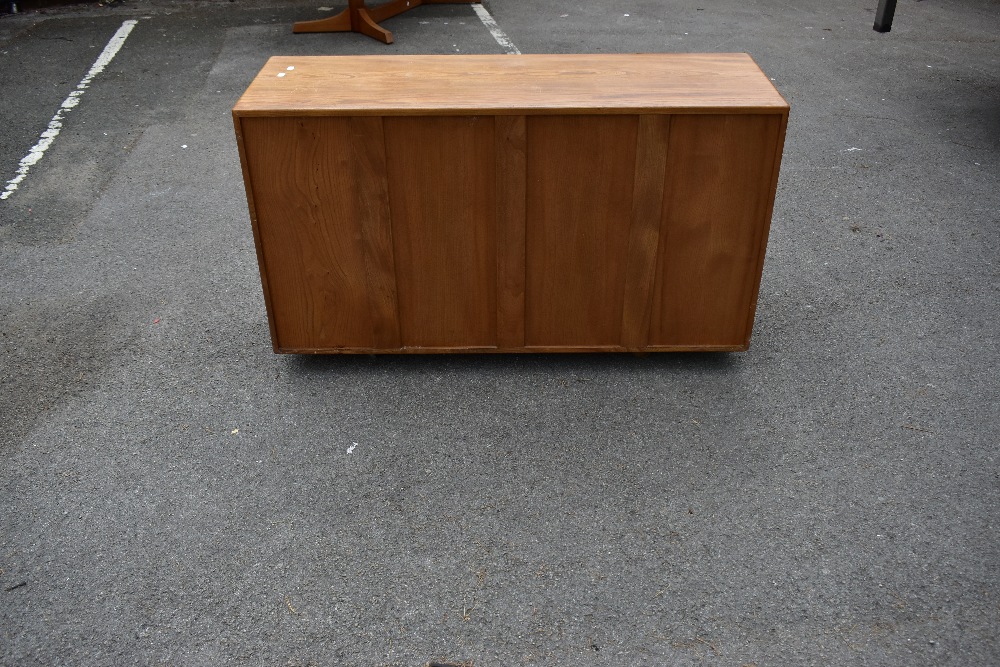 ERCOL; a light elm sideboard, the three panel doors above two base drawers, width 129cm, depth 43cm, - Image 4 of 12