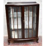 A 1930s mahogany display cabinet, the pair of glazed doors enclosing two fixed shelves and mirror
