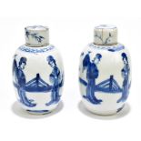 A pair of 18th century Chinese blue and white porcelain tea caddies and covers, painted with maidens