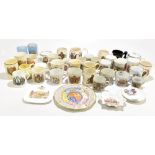 A collection of assorted commemorative mugs and beakers, various examples including WWI peace