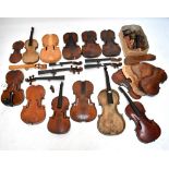 A viola (for restoration), a quantity of violin bodies, necks with scrolls, parts, etc.