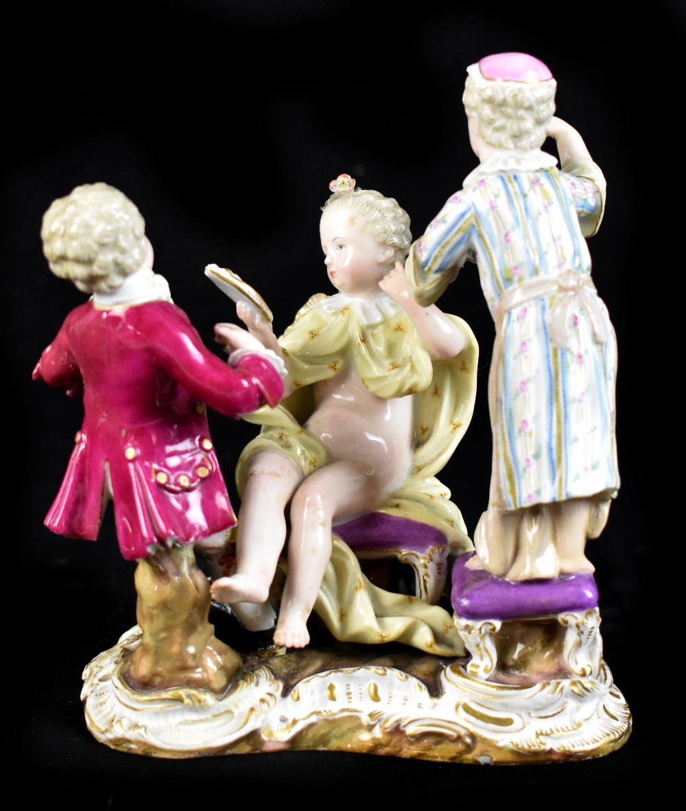 MEISSEN; a porcelain group of a maiden seated upon a chair with two attendants beside, on rococo
