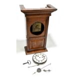 An Edwardian oak eight day mantel clock, with enamel Roman numeral dial and movement striking on a