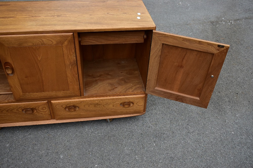 ERCOL; a light elm sideboard, the three panel doors above two base drawers, width 129cm, depth 43cm, - Image 8 of 12