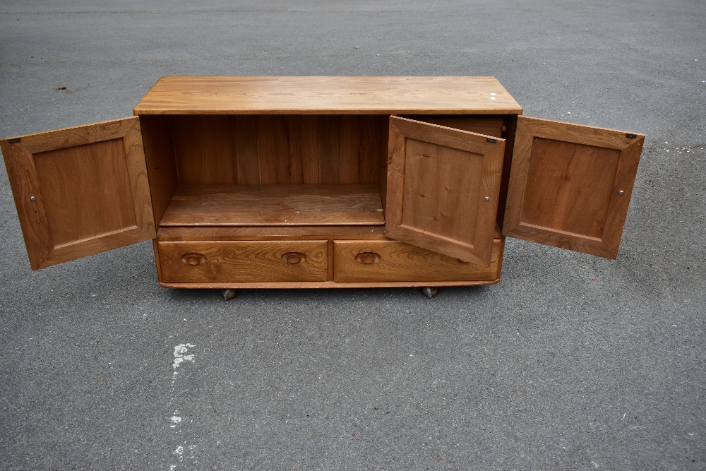 ERCOL; a light elm sideboard, the three panel doors above two base drawers, width 129cm, depth 43cm, - Image 7 of 12