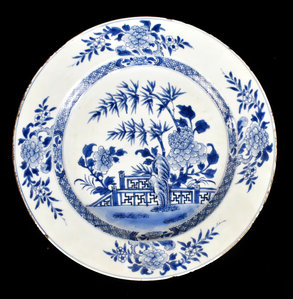 An 18th century Chinese Export blue and white porcelain wall charger decorated with lotus flowers