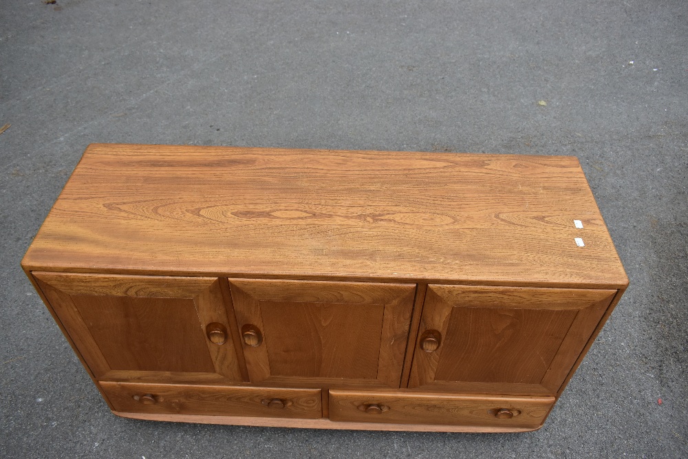 ERCOL; a light elm sideboard, the three panel doors above two base drawers, width 129cm, depth 43cm, - Image 5 of 12