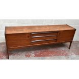 YOUNGER; a mid-century teak sideboard with three drawers flanked by two panelled cupboard doors