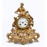 A 19th century gilt spelter eight day mantel clock, the dial set with Roman numeral dial and