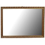 A mid-20th century carved giltwood framed rectangular wall mirror, the carved decoration in the