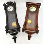 Two walnut and stained beech Vienna regulator type wall clocks, one with an Arabic chapter ring, the