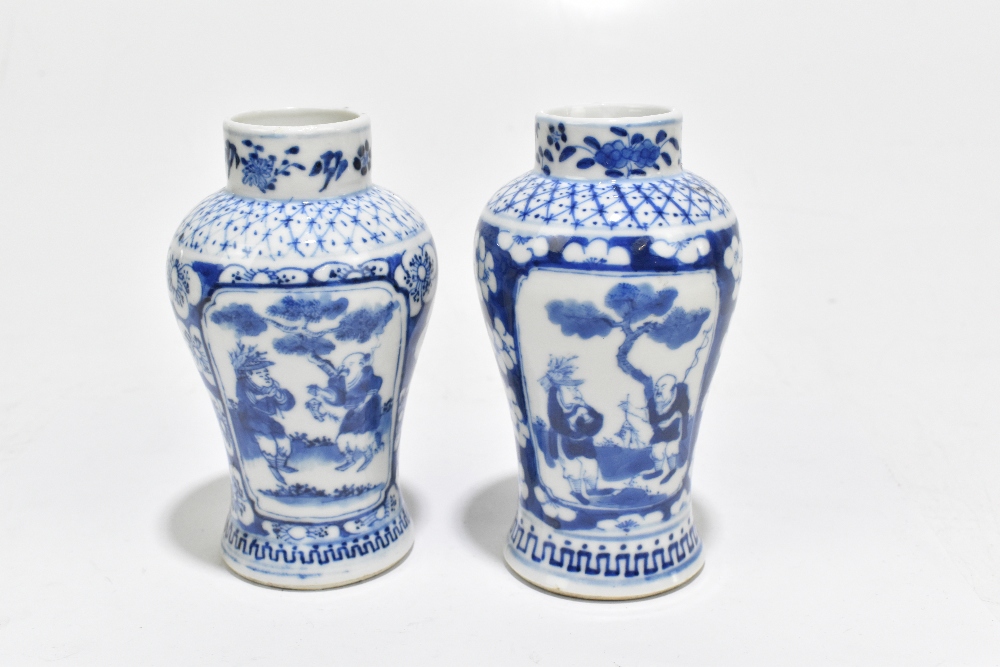 A pair of late 19th century Chinese Kangxi style blue and white vases, decorated with panels of - Image 3 of 6